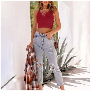 Detail of burgundy ribbed knit crop top with buttoned Henley neckline and texture