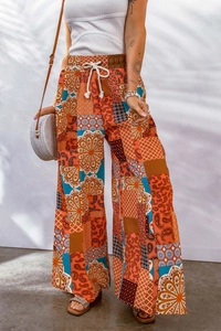 Detail of bohemian wide-leg trousers featuring paisley prints and drawstring elastic waist