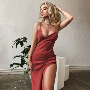 Detail of elegant dark red satin V-neck dress featuring high side slit and sleek fabric