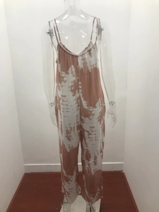 Detail of tie-dye wide leg jumpsuit with thin straps shown on a transparent mannequin