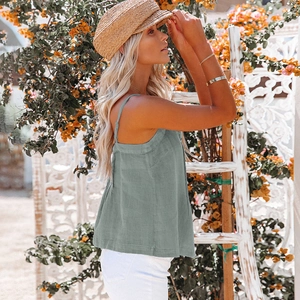 Detailed texture of sage green cotton linen fabric on a minimalist thin strap camisole top