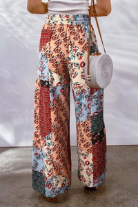 Detail of high waisted floral wide leg trousers with colorful bohemian patchwork pattern