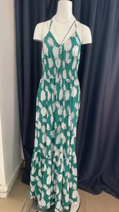 Close-up of tropical pineapple print on a green smocked waist maxi dress for women