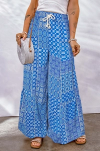 Detail of high-waisted wide leg pants with blue bohemian patchwork floral print design