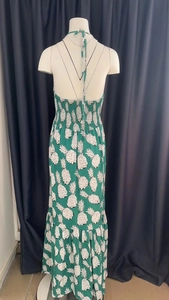 Detail of green floral halter dress with elastic waist and white pineapple print pattern