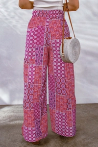 Detail of high waisted wide leg trousers featuring boho paisley patchwork floral prints