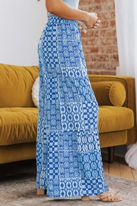 Detail of high-waist floral wide-leg pants with bohemian print and white drawstring
