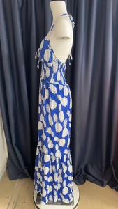 Detail of high waist smocking and pineapple print on a blue halter maxi dress