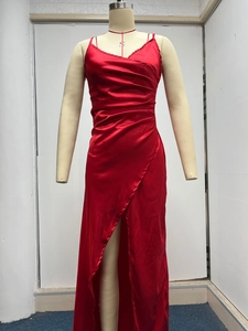 Detail of red satin dress with V-neck, ruched waist design, and high side slit feature