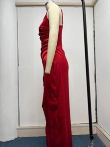 Detail view of red satin maxi dress with side ruching and thin straps on mannequin