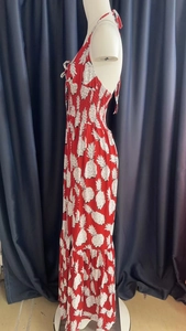 Detail of red floral halter neck maxi dress with pineapple print and smocked bodice