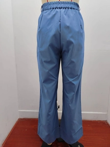 Detail of high waist elastic waistband with pleats on dark blue wide leg trousers