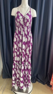 Detail of purple halter neck maxi dress with white pineapple print and tiered skirt layers