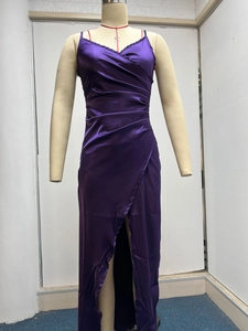 Detail view of deep purple satin dress with pleated wrap bust and elegant high leg slit
