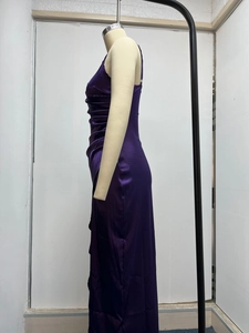 Detail of deep purple satin maxi dress with side ruched texture and silky finish