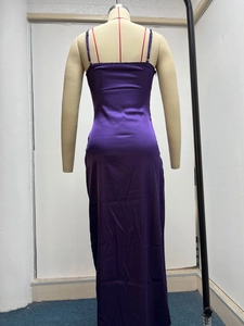 Detail of a dark purple satin maxi dress featuring a low back and thin shoulder straps
