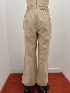 Rear view detail of khaki high-waisted wide leg trousers showing elastic waistband and drape