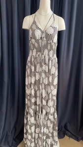 Detail of smocked waist and white pineapple print on a grey halter maxi dress