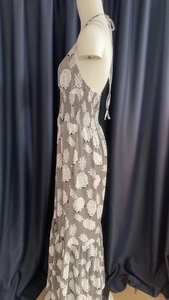 Close-up of halter neck straps and pineapple print on tiered maxi dress bodice