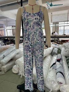Detailed macro view of summer floral jumpsuit fabric and stitching on a mannequin