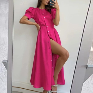 Detail of rose red bubble sleeve dress featuring elegant white pearl buttons and high slit cut