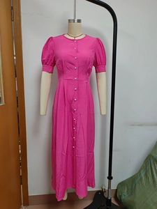 Detail view of pink button-down dress featuring puff sleeves and a slim waistline design