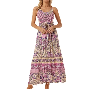 Close-up of bohemian floral print and tassel drawstring on a flowy v-neck beach maxi dress