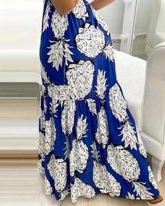 Detail of blue maxi dress with white pineapple print and pleated tiered skirt fabric