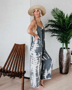 Detail view of tie-dye wide-leg jumpsuit with spaghetti straps and open back design