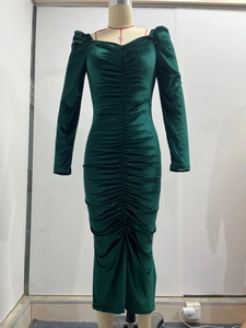 Close-up of ruched dark green velvet dress featuring a slim-fit V-neck and long sleeves