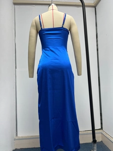 Detail view of glossy bright blue satin long dress with thin straps and open back design