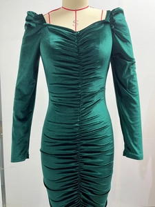 Detailed view of dark green velvet dress featuring elegant ruched texture and slim fit design