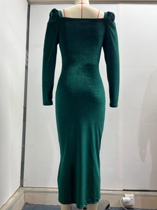 Detail view of dark green velvet maxi dress showing ruched waist and slit hem textures