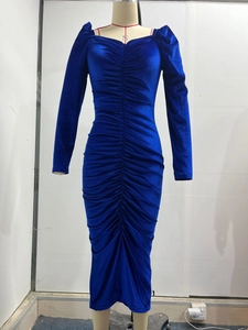 Close-up of royal blue velvet dress with elegant ruched details and v-neckline