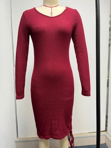 Close-up of dark red ribbed knit fabric on a slim-fit long sleeve dress with round neck