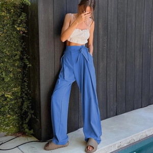 Detail view of high waist blue wide leg trousers with drawstring waist and loose fit