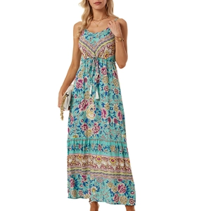 Detail of light blue bohemian floral dress with V-neckline and white tassel drawstring
