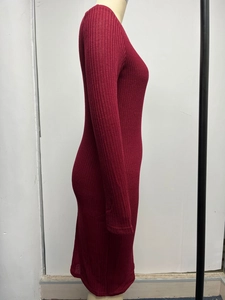 Detailed side view of ribbed knit texture on a slim fit wine red long sleeve dress
