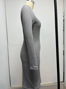 Detail view of grey ribbed knit dress texture and side slim fit tailoring on mannequin