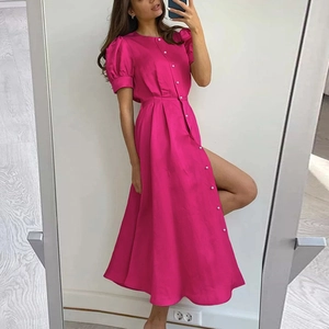 Detail of rose pink dress with short puff sleeves, pearl buttons, and a side high split cut
