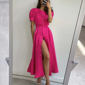 Detail of rose red dress with pearl buttons, puff sleeves and a high slit hemline