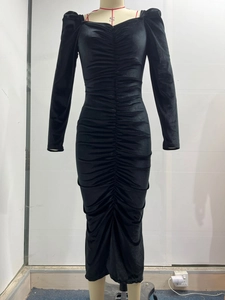 Close-up of ruched black velvet dress with elegant heart-shaped neckline and puff sleeves
