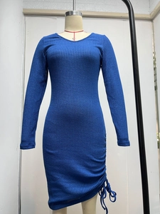 Detail of blue ribbed knit fabric with side drawstring and ruching on the dress