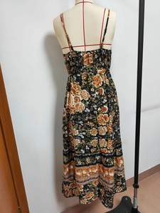Detail of bohemian floral maxi dress featuring adjustable straps and elastic smocked back