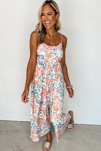 Detailed view of floral summer jumpsuit with thin straps and flowing wide-leg silhouette
