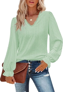 Close-up of light green V-neck top with intricate eyelet embroidery and lace trim details