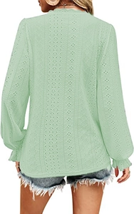 Detail of mint green V-neck shirt featuring hollow-out lace fabric and ruffled sleeve cuffs
