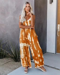 Detail of tie-dye jumpsuit featuring a V-neckline and wide-leg summer design