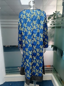 Vue arrière d'une robe rétro à col en V avec imprimé floral bleu et bordures noires contrastées