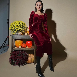 Detail of wine red velvet dress showing ruched texture and retro square neckline design